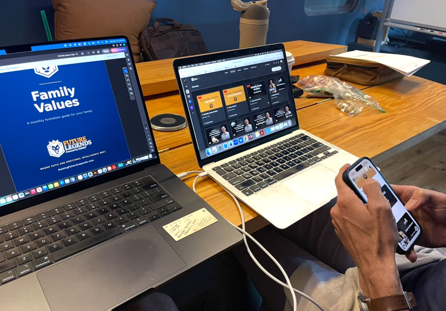 Two laptops on a worktable showing the KidsRQ 'Family Values' formation guide and the Future Legends course dashboard in progress.